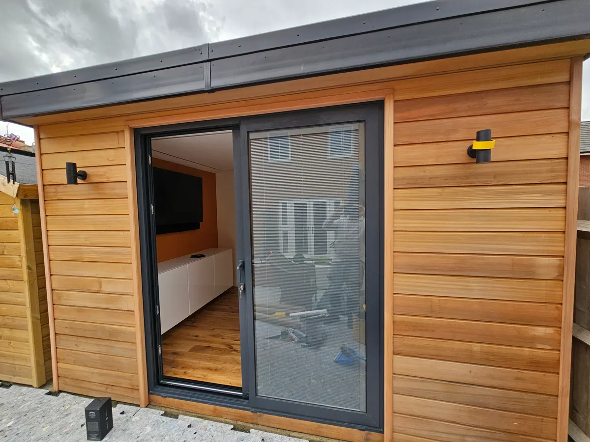 Cedar-clad garden room with bi-fold doors