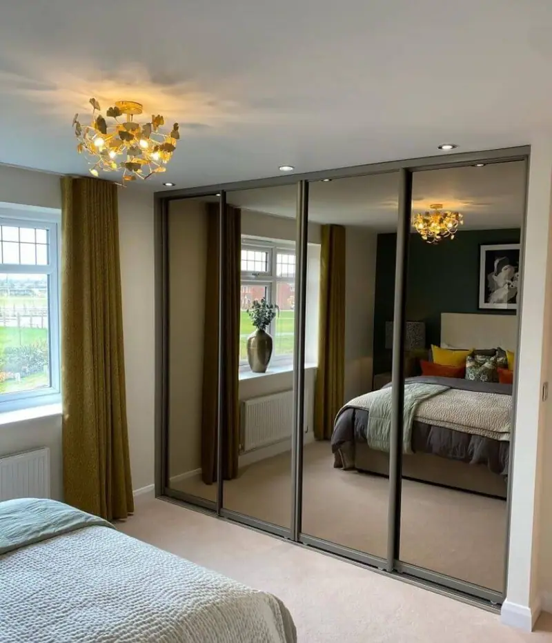 Mirrored sliding-door fitted wardrobes in a bedroom